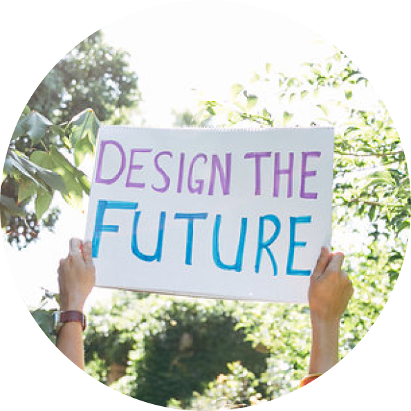 A pair of hands holding a sign above their heads, the sign reads "design the future"
