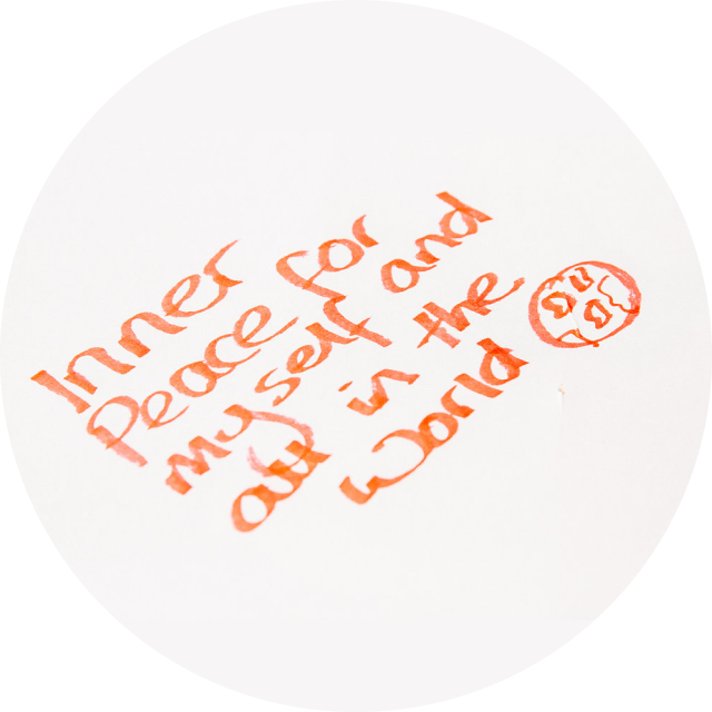 Handwritten text on a piece of paper that reads "inner peace for myself and all in the world"
