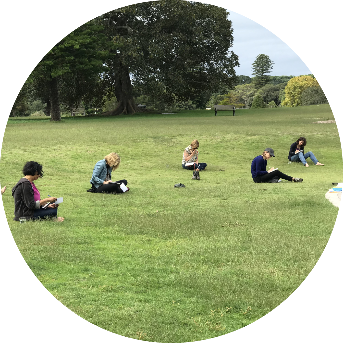 Women journalling on the grass